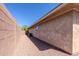 Side yard with desert landscaping, stucco wall, and air conditioning units at 4557 W South Butte Rd, San Tan Valley, AZ 85144