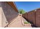 The side yard has low maintenance rock ground cover with a drip system for growing a garden at 4557 W South Butte Rd, San Tan Valley, AZ 85144
