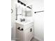 Bathroom featuring a white vanity cabinet with dark hardware, black fixtures, and bright lighting at 4902 E Charter Oak Rd, Scottsdale, AZ 85254