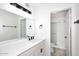 Fresh bathroom with a large mirror, stylish light fixture, and a tiled walk-in shower at 4902 E Charter Oak Rd, Scottsdale, AZ 85254