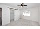 Bright bedroom features a ceiling fan, large window, and a sliding barn door to the walk in closet at 4902 E Charter Oak Rd, Scottsdale, AZ 85254