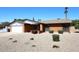 Charming red brick single-story home with desert landscaping and an attached garage at 4902 E Charter Oak Rd, Scottsdale, AZ 85254