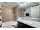 Bathroom featuring a tiled shower/tub, granite countertop, and dark wood cabinets at 5122 E Shea Blvd # 1020, Scottsdale, AZ 85254