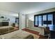 Bedroom featuring wood floors, closet with mirrored doors, a desk and a large window at 5122 E Shea Blvd # 1020, Scottsdale, AZ 85254