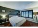 Cozy bedroom with a queen-sized bed, dark accent wall, and modern lighting at 5122 E Shea Blvd # 1020, Scottsdale, AZ 85254