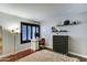 Bedroom with desk, dark wood floors, window with wooden blinds and decorative shelving at 5122 E Shea Blvd # 1020, Scottsdale, AZ 85254