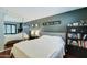 A stylish bedroom features a full-length mirror, a queen bed, and modern decor at 5122 E Shea Blvd # 1020, Scottsdale, AZ 85254