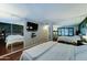 A lovely main bedroom with wood floors, a television, and sliding door mirrored closets at 5122 E Shea Blvd # 1020, Scottsdale, AZ 85254