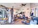 Community gym with mirrored wall, ceiling fan, treadmill, elliptical, and weight machines at 5122 E Shea Blvd # 1020, Scottsdale, AZ 85254