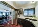 Open kitchen view, stainless steel appliances, dark cabinets, and adjoining dining area at 5122 E Shea Blvd # 1020, Scottsdale, AZ 85254
