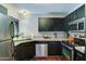 Updated kitchen with stainless steel appliances, granite countertops, and dark wood cabinets at 5122 E Shea Blvd # 1020, Scottsdale, AZ 85254