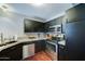 Kitchen featuring stainless steel appliances, granite countertops, and dark wood cabinets at 5122 E Shea Blvd # 1020, Scottsdale, AZ 85254