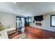 Bright living room boasting hardwood floors, a wall mounted TV, and a modern fireplace at 5122 E Shea Blvd # 1020, Scottsdale, AZ 85254