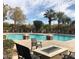 Community pool with seating area, fire pit, palm trees, and well-maintained landscaping at 5122 E Shea Blvd # 1020, Scottsdale, AZ 85254