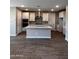 Modern kitchen with an island, stylish range hood, and stainless steel appliances at 5633 N 205Th Ln, Buckeye, AZ 85396