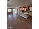 Bright, open kitchen with an island, stainless appliances, and a sliding glass door at 5633 N 205Th Ln, Buckeye, AZ 85396