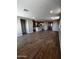 Open concept living space with wood-look tile, recessed lighting, and modern kitchen at 5633 N 205Th Ln, Buckeye, AZ 85396