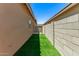 The backyard includes artificial turf next to a block wall, creating a low-maintenance outdoor space at 5641 N 205Th Ln, Buckeye, AZ 85396