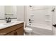 Bright bathroom showcasing a shower-tub combo with black fixtures and a stylish vanity with a white countertop at 5641 N 205Th Ln, Buckeye, AZ 85396