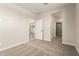 Large bedroom with carpet flooring, multiple doors, and an ensuite bathroom at 5641 N 205Th Ln, Buckeye, AZ 85396