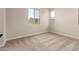 Neutral-toned bedroom with plush carpeting and two windows for ample natural light at 5641 N 205Th Ln, Buckeye, AZ 85396