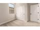 Cozy bedroom with sliding closet doors, carpeted floor, and natural light at 5641 N 205Th Ln, Buckeye, AZ 85396