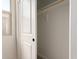 An open closet featuring a wooden rod and white walls that offers plenty of space for storage at 5641 N 205Th Ln, Buckeye, AZ 85396