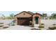 Charming single-story home featuring a welcoming entrance and a two-car garage at 5641 N 205Th Ln, Buckeye, AZ 85396