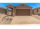 Charming single-story home with a well-maintained front yard and a two-car garage at 5641 N 205Th Ln, Buckeye, AZ 85396