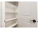 Well-organized pantry with white shelving and a conveniently placed door at 5641 N 205Th Ln, Buckeye, AZ 85396
