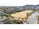 Expansive aerial view of vacant land with mountain views and scattered vegetation near a residential area at 6506 W Bent Tree Dr, Phoenix, AZ 85083