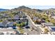 Scenic aerial view of a suburban neighborhood nestled in a desert landscape with mountain backdrop at 6506 W Bent Tree Dr, Phoenix, AZ 85083