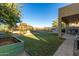Spacious backyard with playground, swing set, and lush lawn, perfect for Gathering activities at 6506 W Bent Tree Dr, Phoenix, AZ 85083