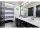 Well-lit bathroom features sleek vanity, modern fixtures, and a stylish shower curtain at 6506 W Bent Tree Dr, Phoenix, AZ 85083