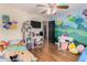 Whimsical ' bedroom with colorful wall art, a large TV, and plenty of space for activities at 6506 W Bent Tree Dr, Phoenix, AZ 85083