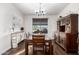 Traditional dining room featuring a large wood table, chandelier lighting, and elegant wood furnishings at 6506 W Bent Tree Dr, Phoenix, AZ 85083