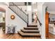 A grand entryway features a staircase with striking leopard print treads, contrasted against sleek black accents at 6506 W Bent Tree Dr, Phoenix, AZ 85083