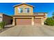 Exterior view of a two-story home with a spacious driveway and attached two-car garage with light brown garage doors at 6506 W Bent Tree Dr, Phoenix, AZ 85083