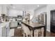Open kitchen featuring white cabinetry, stainless steel appliances and a large island with barstool seating at 6506 W Bent Tree Dr, Phoenix, AZ 85083