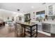Open concept kitchen featuring stainless steel appliances, a large island, barstool seating, and lots of natural light at 6506 W Bent Tree Dr, Phoenix, AZ 85083