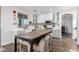 Bright and modern kitchen featuring a large island with barstool seating, and a stainless steel range at 6506 W Bent Tree Dr, Phoenix, AZ 85083