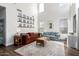 Bright living room featuring vaulted ceiling, decorative mirror, a large window and plush seating for a cozy atmosphere at 6506 W Bent Tree Dr, Phoenix, AZ 85083