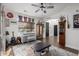 Living room featuring eclectic decorations, a piano, and cozy furnishings under a ceiling fan and natural light at 6506 W Bent Tree Dr, Phoenix, AZ 85083