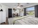 Bright main bedroom with wood floors, ceiling fan, large window, and office nook at 6506 W Bent Tree Dr, Phoenix, AZ 85083