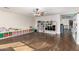 Playroom with wood floors, ceiling fan, and storage shelves filled with toys and books at 6506 W Bent Tree Dr, Phoenix, AZ 85083