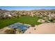 Enjoy this beautiful aerial view of community park featuring tennis and basketball courts near landscaped homes at 6520 E Sugarloaf St, Mesa, AZ 85215