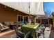 Outdoor patio with dining area, overhead awning and comfortable seating area with fire pit at 6520 E Sugarloaf St, Mesa, AZ 85215