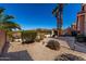 Landscaped backyard with gravel beds, desert foliage, and plenty of space for outdoor entertaining at 6520 E Sugarloaf St, Mesa, AZ 85215