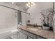 Cozy bathroom includes a vanity, large mirror and combination shower and tub at 6520 E Sugarloaf St, Mesa, AZ 85215