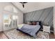 This stylish bedroom features an accent wall, plush rug, and bright airy light from outdoor access at 6520 E Sugarloaf St, Mesa, AZ 85215